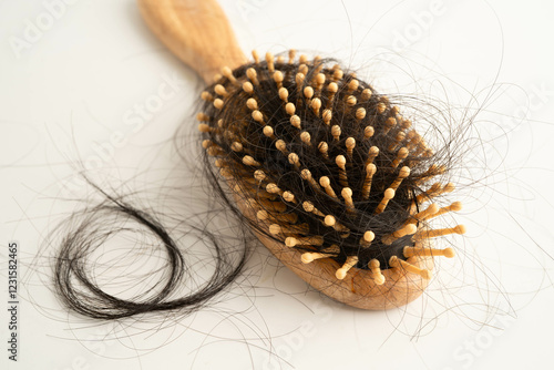 Hair loss fall with comb brush isolated on white background. photo