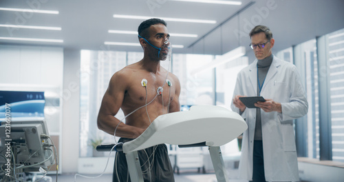 Athlete Wearing Oxygen Mask for a Treadmill Exercise Test in a Laboratory, Monitored by Sensors and Breathing Apparatus, Showcasing Fitness Assessment and Health Monitoring in a Controlled Environment photo