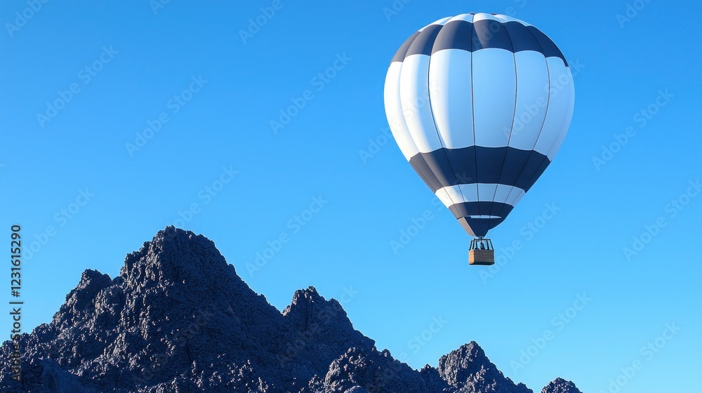 Fototapeta premium White and Gray Hot Air Balloon Over Dark Mountains Under Blue Sky