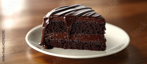 Rich triple chocolate cake slice on a white plate with glossy drippy chocolate ganache, dark brown hues, set against a warm wooden background.