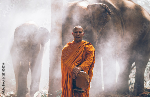 Fotografia Thai monks walking in the jungle with elephants