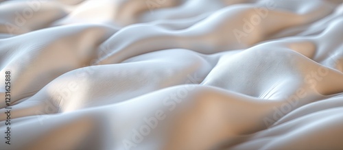 Satin fabric with soft undulating waves in shades of white and cream creating a luxurious texture and elegant appearance for textile backgrounds. photo