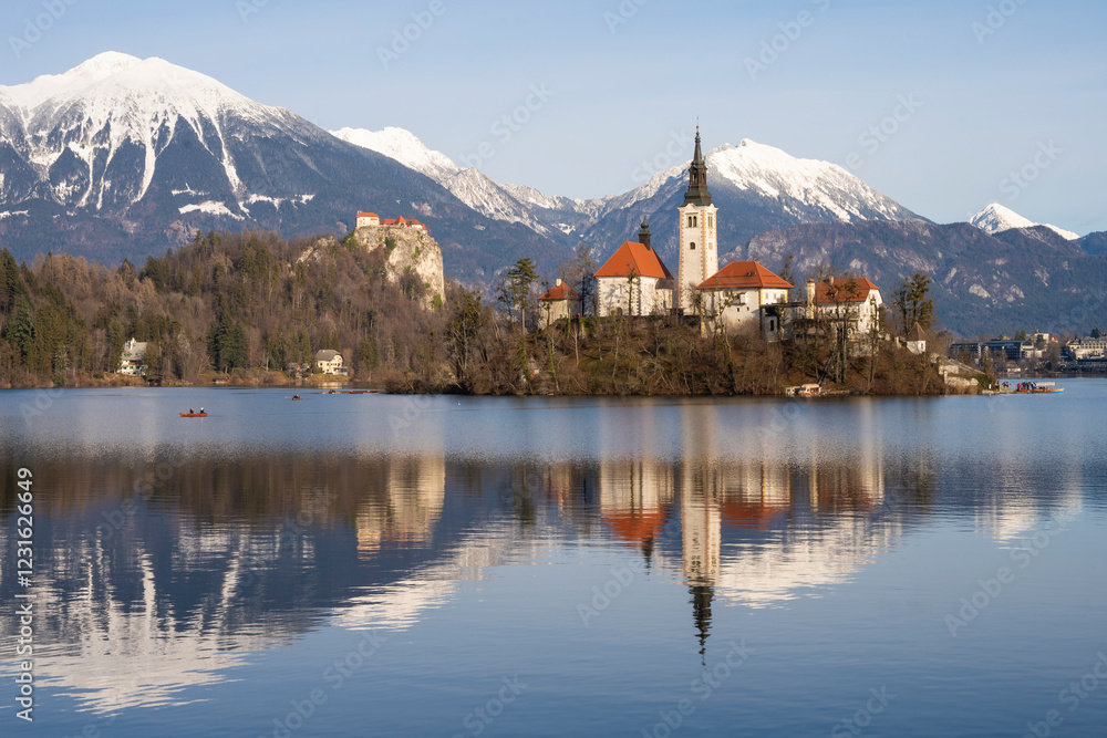 Beautiful mountains and Bled lake with small Pilgrimage Church. Bled lake and island with Church of the Assumption of Maria in winter. Bled, Slovenia. Beautiful mountains and Bled lake with small Pilgrimage Church. Bled lake and island with Church of the Assumption of Maria in winter. Bled, Slovenia.