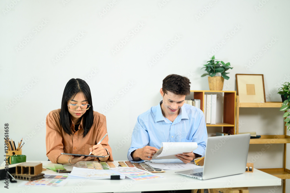 Creative team of interior designers working together in a modern office Creative team of interior designers working together in a modern office