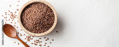 Fresh riceberry grains in round wooden bowl with wooden spoon, showcasing minimalist setup. natural tones create calming atmosphere photo