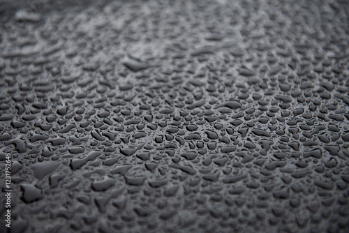 Glistening Raindrops on black Car Hood. Hydrophobic Coating