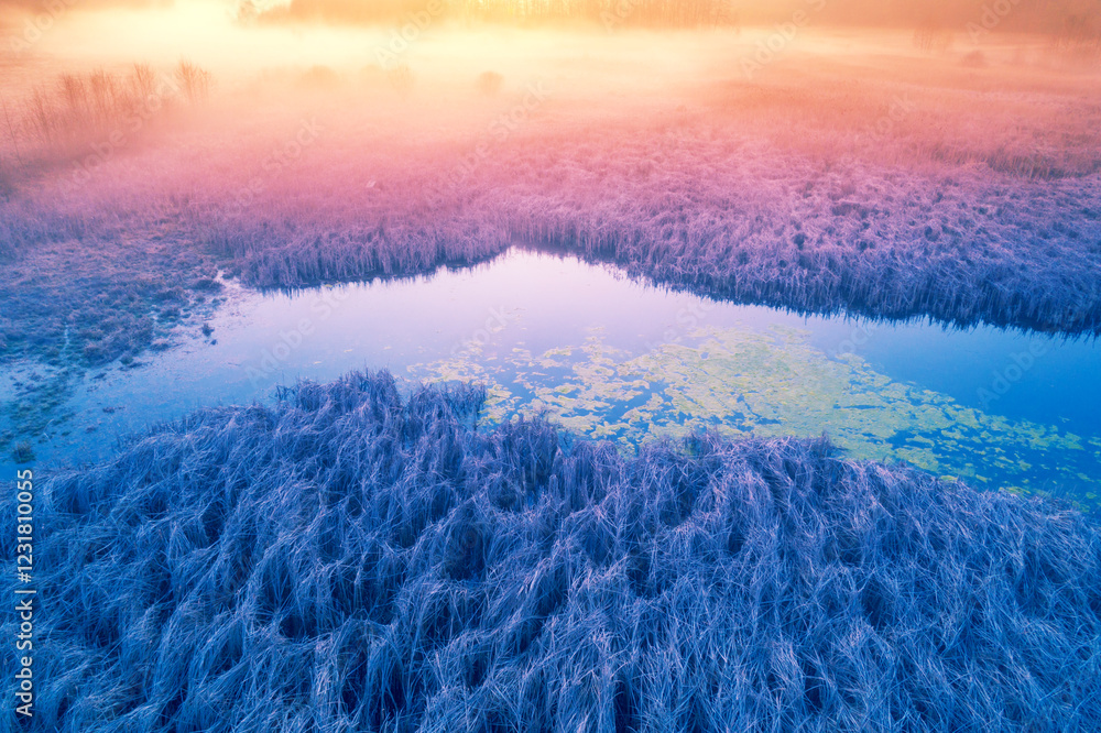 Magic sunrise over the lake. Misty early morning, rural landscape, wilderness, mystical feeling. Serenity lake in magical light