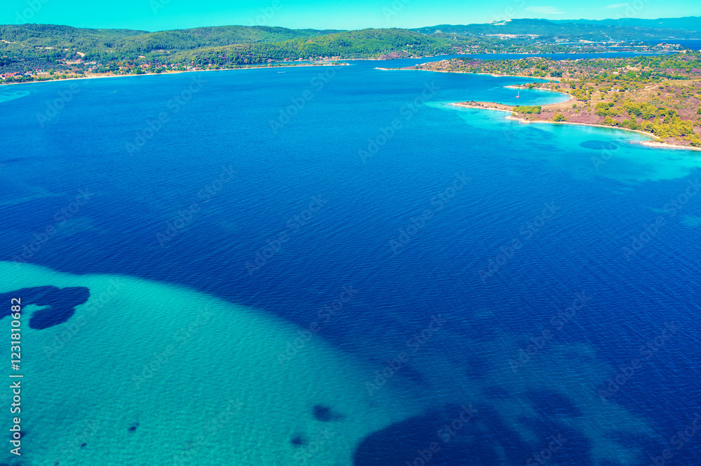 Panoramic view of seascape with beautiful bay on a sunny day. View from above. Vourvourou, Greece, Europe