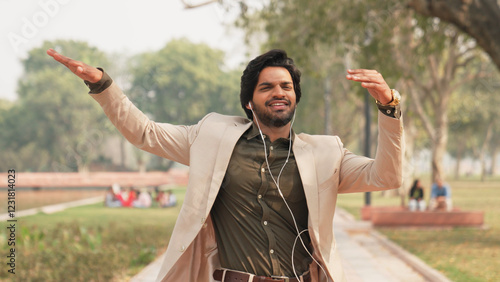 Happy Indian Businessman Listening to Music and Dancing While Walking