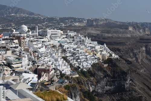 The dramatic steep views over the edge of the volcano crater of Santorini Island overlooking the blue Mediterranean Sea photo