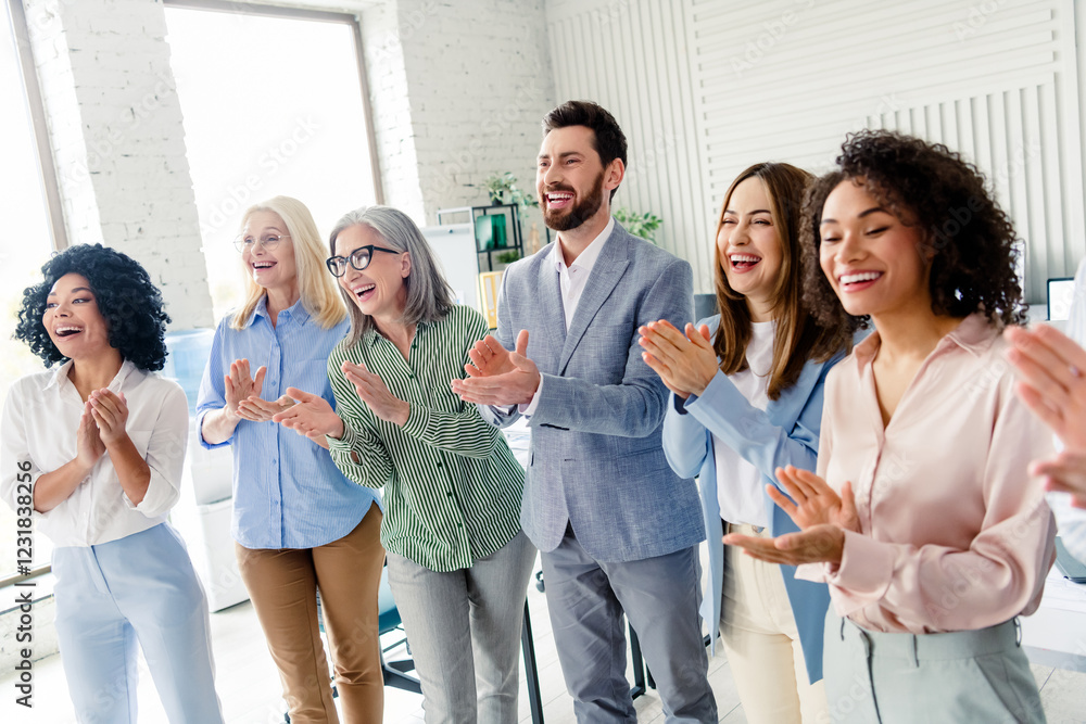 Diverse group of colleagues applauding in an office reflecting teamwork and positivity, multi-age Diverse group of colleagues applauding in an office reflecting teamwork and positivity, multi-age