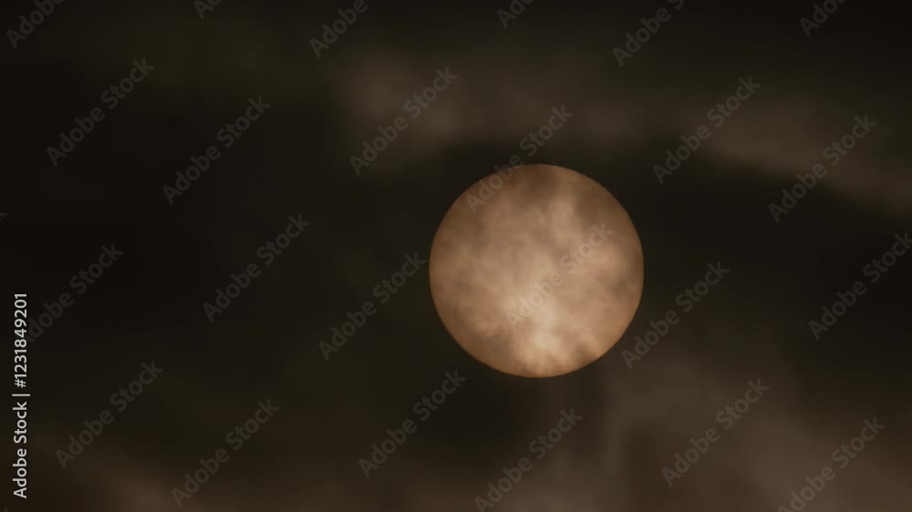 Dark clouds rapidly moving across the sky, obscuring the sun and dimming its light, atmospheric distortions, dramatic close-up shot Dark clouds rapidly moving across the sky, obscuring the sun and dimming its light, atmospheric distortions, dramatic close-up shot