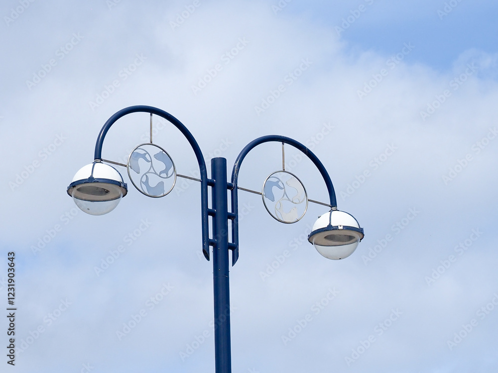 Decorative street lighting showing blue painted curved lamp post with globe streetlights Decorative street lighting showing blue painted curved lamp post with globe streetlights