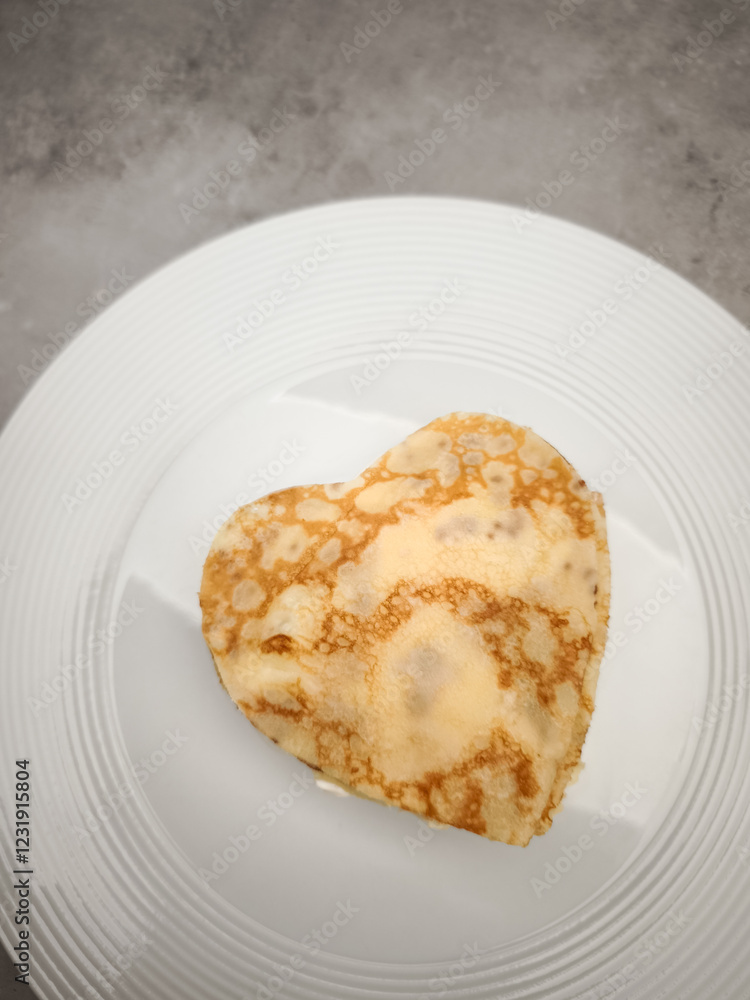 Heart shaped crepes, pancake with white yogurt sitting on white plate, symbolizing romantic morning meal with sweet culinary artistry for Mother's Day Valentines copy space Heart shaped crepes, pancake with white yogurt sitting on white plate, symbolizing romantic morning meal with sweet culinary artistry for Mother's Day Valentines copy space