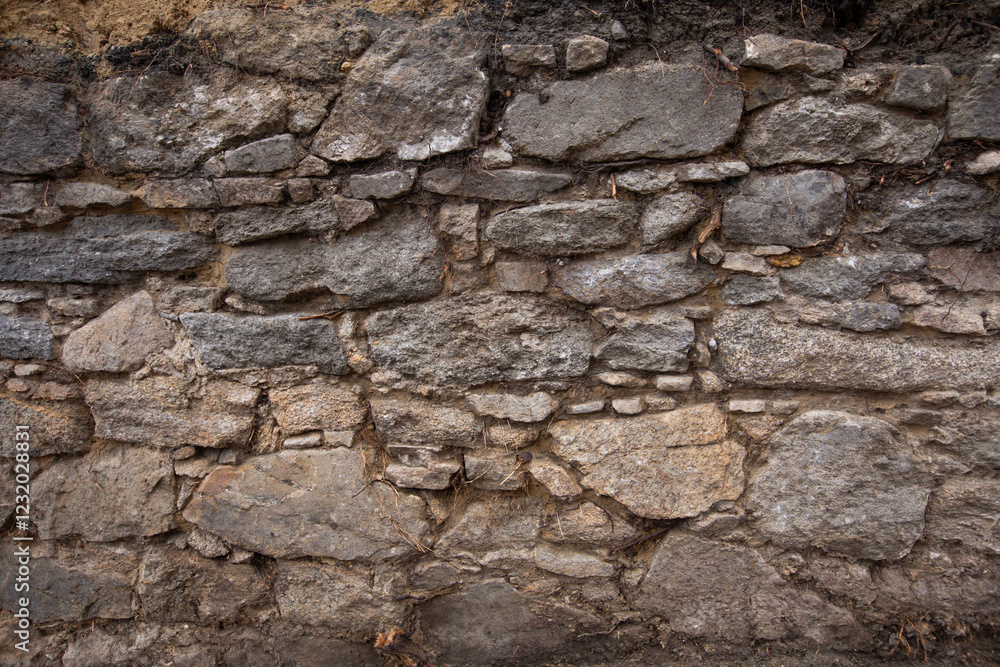 old stone wall made of granite stone old stone wall made of granite stone
