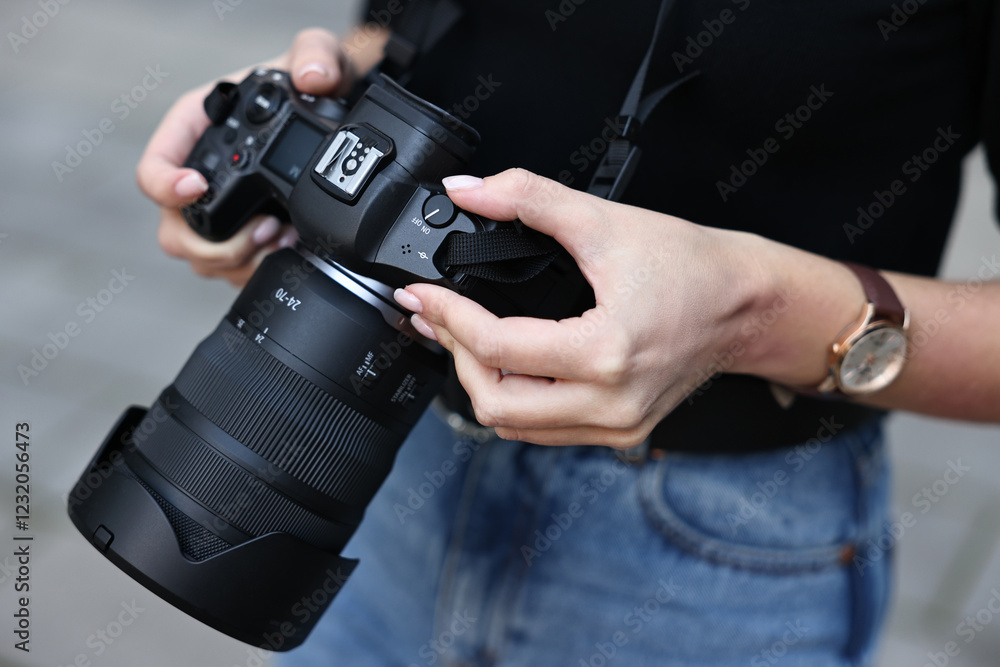 Fototapeta premium Professional photographer with digital camera outdoors, closeup