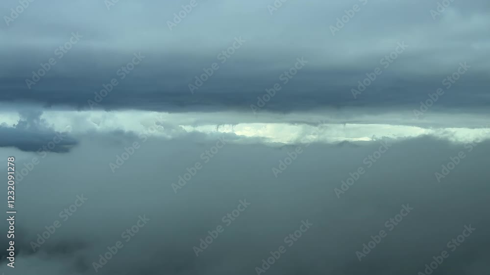 Iimmersive pilot’s perspective from a jet cockpit flying between layers of threatening grey color stratus clouds in a winter sky. Real time flight. 4K 60FPS Iimmersive pilot’s perspective from a jet cockpit flying between layers of threatening grey color stratus clouds in a winter sky. Real time flight. 4K 60FPS