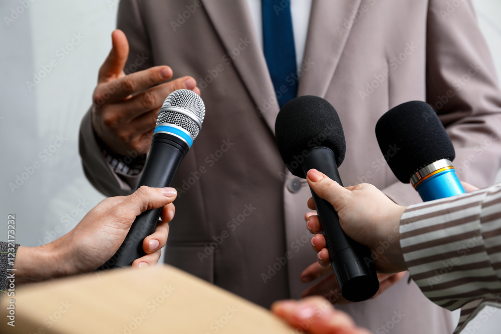 Group of journalists interviewing businessman indoors, closeup Group of journalists interviewing businessman indoors, closeup