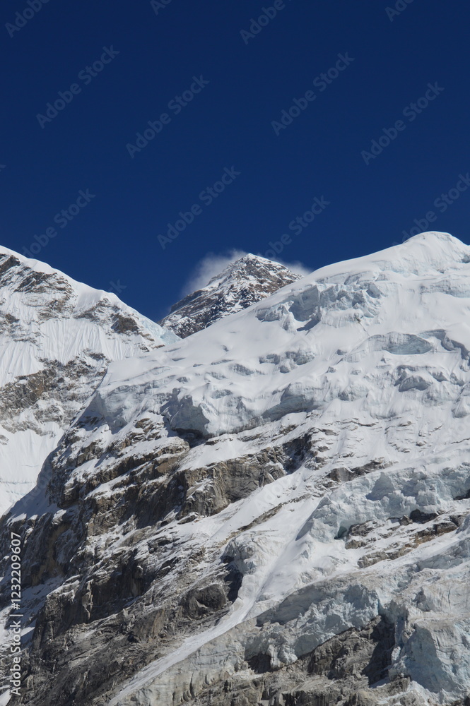 Mount Everest and the Khumbu Icefall Glacier as seen from the valley on the Everest Base Camp Trek, Nepal Mount Everest and the Khumbu Icefall Glacier as seen from the valley on the Everest Base Camp Trek, Nepal