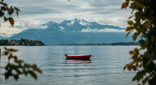 A serene view of lake geneva with a solitary red boat floating peacefully the majestic alps rise in the background under a cloudy sky, framed by vibrant foliage