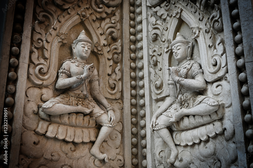 Ancient Statue Craving on the wall at the temple in Thailand Ancient Statue Craving on the wall at the temple in Thailand