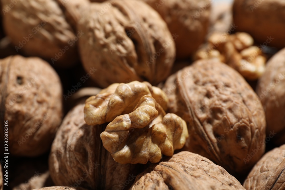 Fresh walnuts in shells and shelled one as background, closeup Fresh walnuts in shells and shelled one as background, closeup