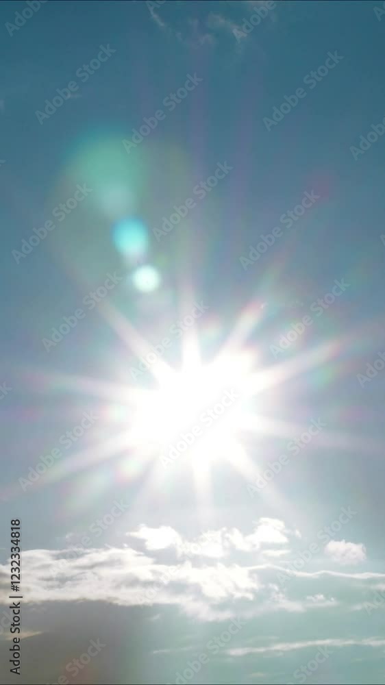 The sun, blue sky, bright sunny rays and clouds - Vertical video. High quality 4k footage The sun, blue sky, bright sunny rays and clouds - Vertical video. High quality 4k footage
