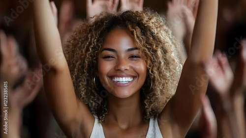 Woman raises arms with joyf...