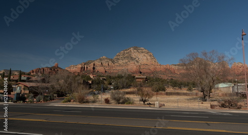 Houses on red sandrock slopes behind Highway 89A in Sedona