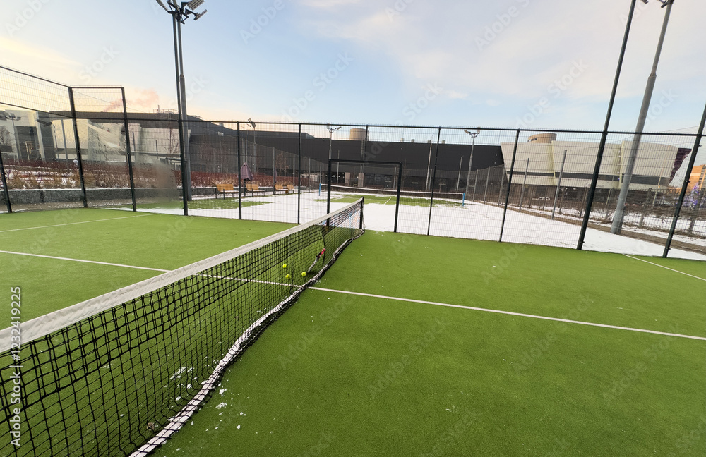 Fototapeta premium Tennis courts covered with snow in a city park in winter.