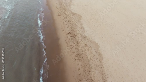 drone footage of a sandy beach shoreline in County Wexford, Ireland