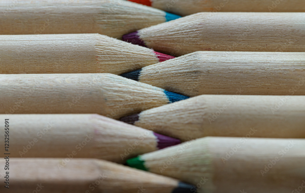 Close-up of Two groups brown crayons are sharp tips and facing collide in a neat row. Wooden pencils to each other arranged in a symmetrical radial, The arrangement of the colors pencils creates.