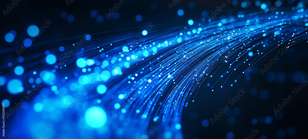 Obraz premium Blue glowing fiber-optic cables with light particles moving rapidly on a dark background