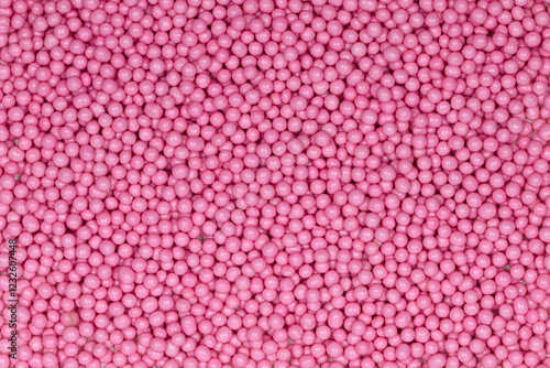Vibrant Pink Sugar Sprinkles Background: Macro Photography of Decorative Candy Pearls Used for Cake Decoration and Confectionery Garnish