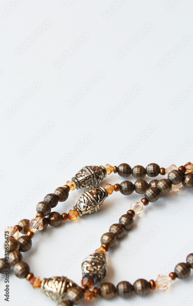 Elegant handcrafted necklace made of brown and bronze beads in vintage style. Sophisticated bijoux close up on white background with copy space available. Women's fashion, female accessory, bijouterie Elegant handcrafted necklace made of brown and bronze beads in vintage style. Sophisticated bijoux close up on white background with copy space available. Women's fashion, female accessory, bijouterie