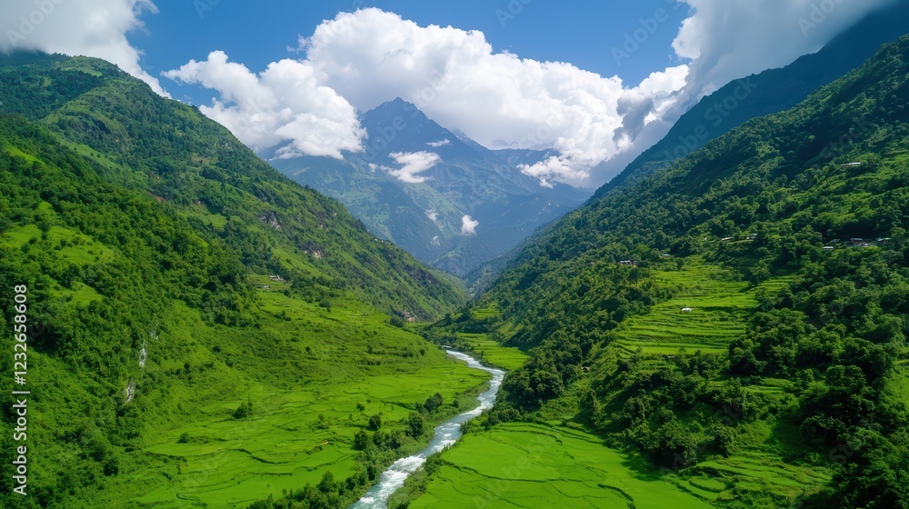 Naklejka premium Lush Green Valley Surrounded by Majestic Mountains and Clear Sky