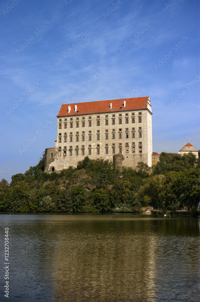 Photograph of a tall castle building on a rock above a pond. Monumental castle. Historic building, sky, monuments. The reflection of the castle on the surface of the pond. Travel, vacation.
Photograph of a tall castle building on a rock above a pond. Monumental castle. Historic building, sky, monuments. The reflection of the castle on the surface of the pond. Travel, vacation.