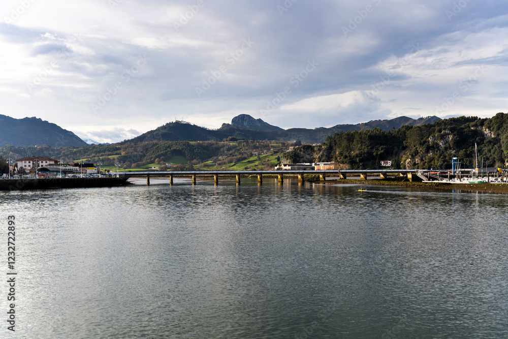 Fototapeta premium Bridge crossing sella river in ribadesella, asturias, spain, under cloudy sky