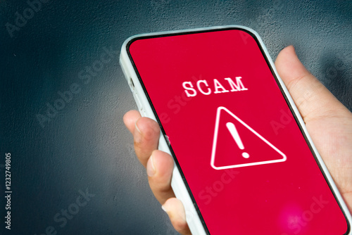 A female user reacts to a scam alert notification on her phone, symbolizing digital safety and online threat detection.