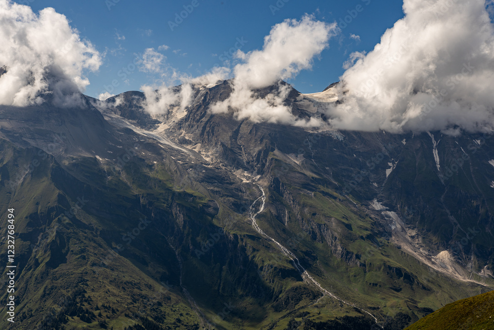 The Grossglockner mountain range with snow on the peaks and a blue sky The Grossglockner mountain range with snow on the peaks and a blue sky