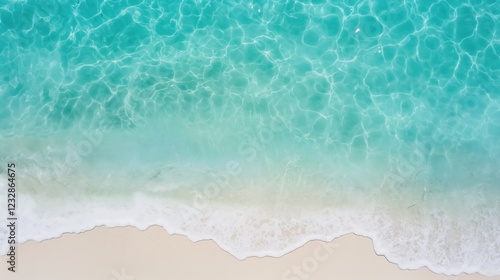 Fototapeta Naklejka Na Ścianę i Meble -  Top view of clear ocean water waves on sandy beach coast. Outdoor background with copy space.