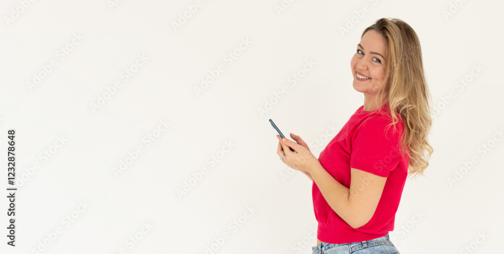 Happy pretty young woman model holding smartphone looking at camera, smiling girl using mobile apps on cell phone standing isolated on white background with cellphone. Happy pretty young woman model holding smartphone looking at camera, smiling girl using mobile apps on cell phone standing isolated on white background with cellphone.