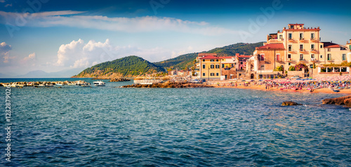 Fototapeta Naklejka Na Ścianę i Meble -  Hot summer scene of Santa Maria di Castellabate puclic beach. Panoramic morning sescxape of Mediterranean sea, Italy, Europe. Vacation concept background.