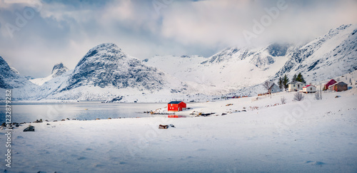 Gloomy morning view of Krystadveien village on the Sandvika bay. Gorgeous winter scene of Lofoten Islans, Norway, Europe. Wonderful seascape of Norwegian sea. Life over polar circle.