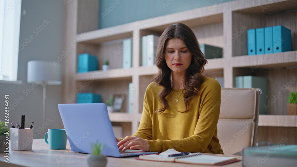 Woman online manager working laptop making notes at notebook in office closeup. Woman online manager working laptop making notes at notebook in office closeup.