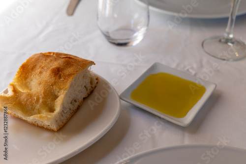 Homemade bread and olive oil for appetizer in restaurant Spain photo