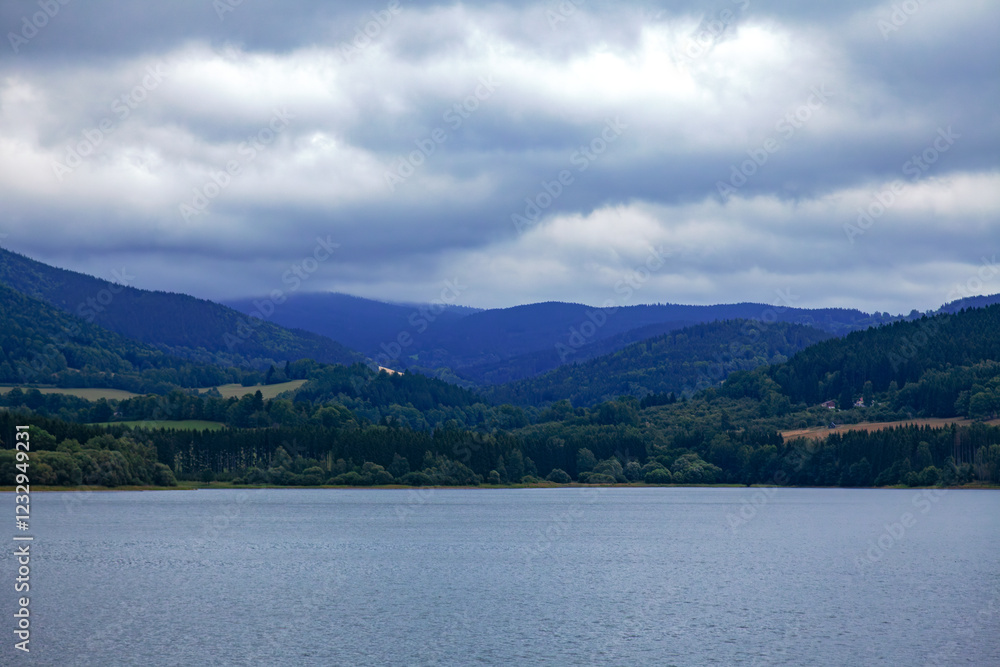 Lake between mountains and forests Lake between mountains and forests