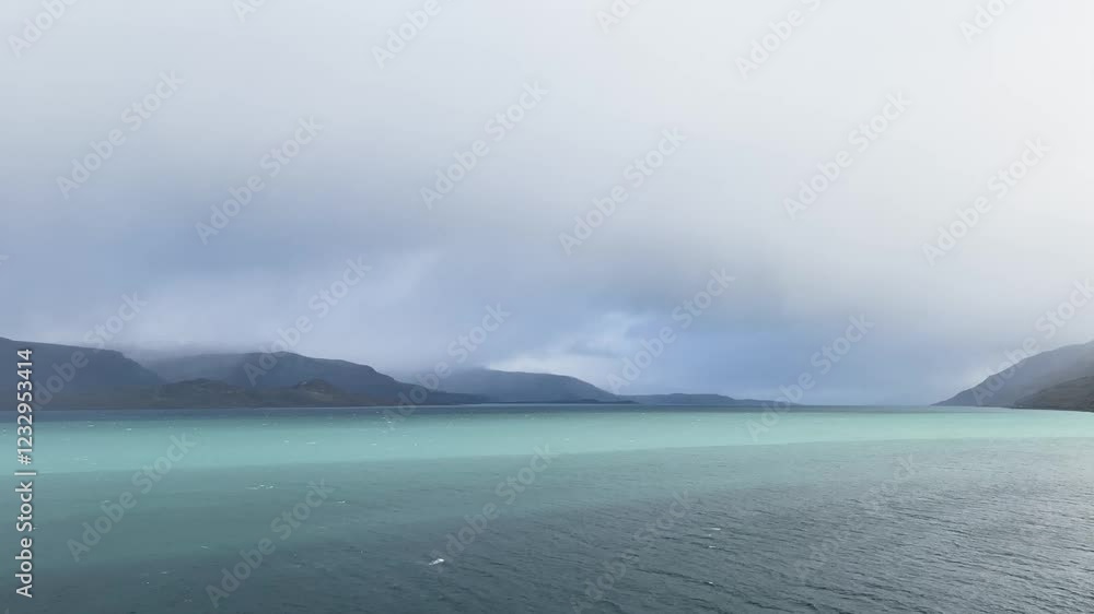 Clouds are passing over mountains by the sea in Lyngel Alps, Norway Clouds are passing over mountains by the sea in Lyngel Alps, Norway