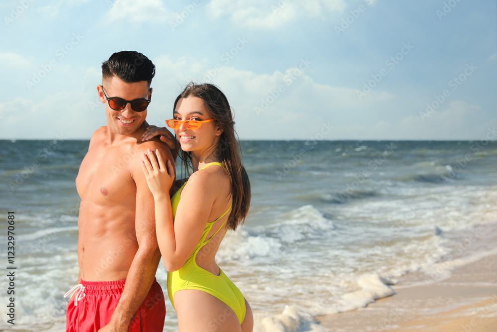 Fototapeta premium Lovely couple spending time together on beach