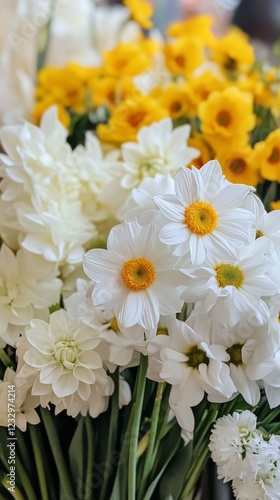 Colorful bouquet of white and yellow flowers at a local market during spring ...